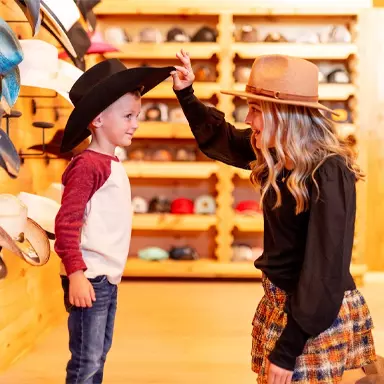 kid trying on a cowboy hat from Williford Mercantile