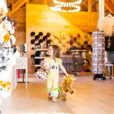 little girl with a stuffed animal from SkyLand Ranch store 