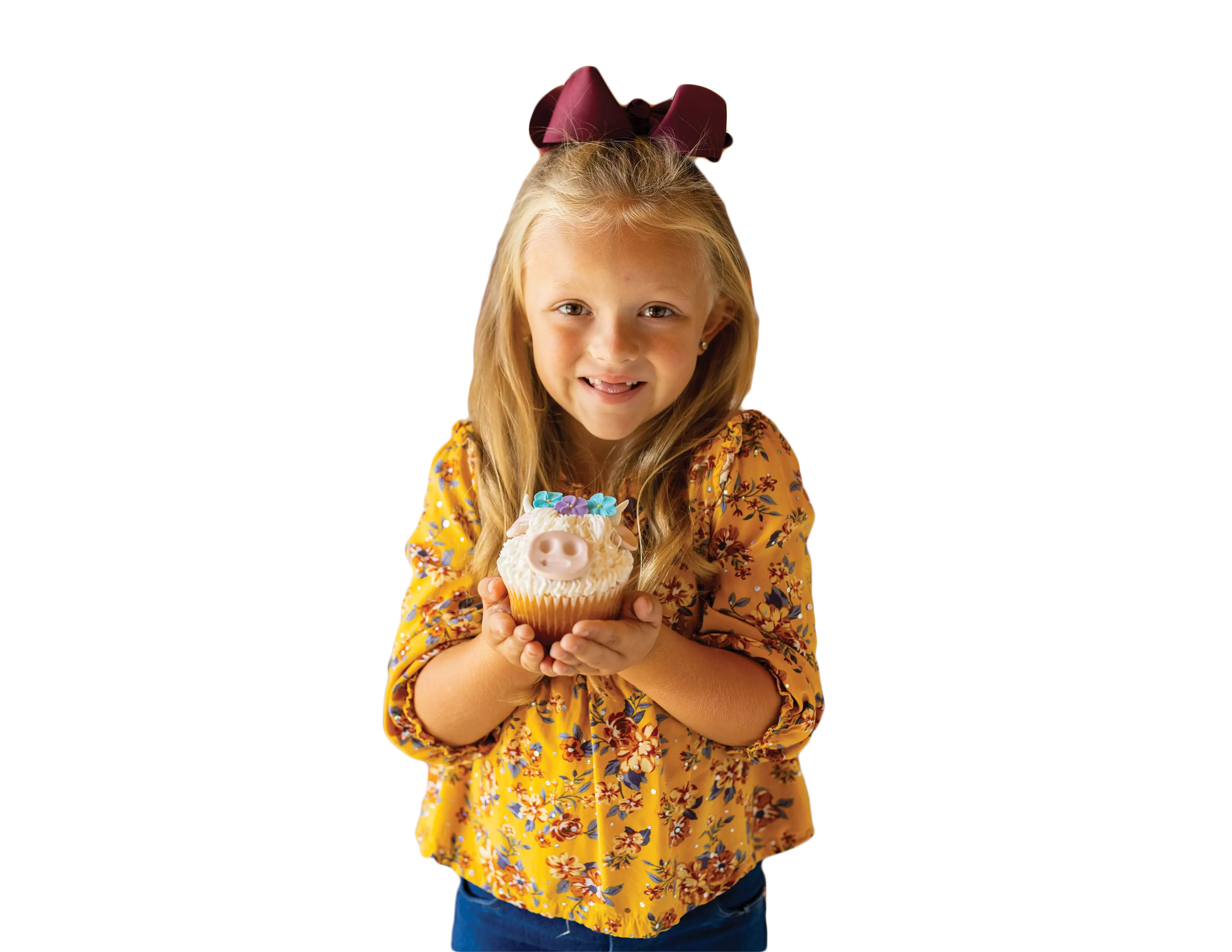 girl holding a cow shaped cupcake 