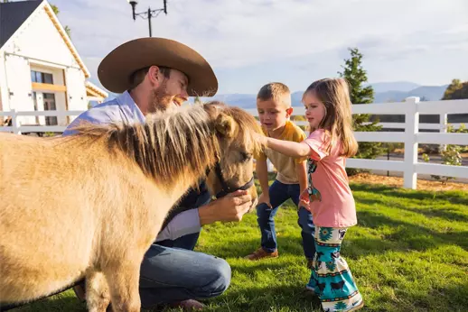 kids petting one of the SkyLand Ranch horses 