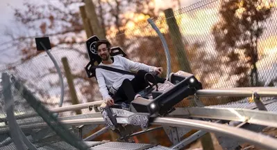 Man riding The Wild Stallion Mountain Coaster