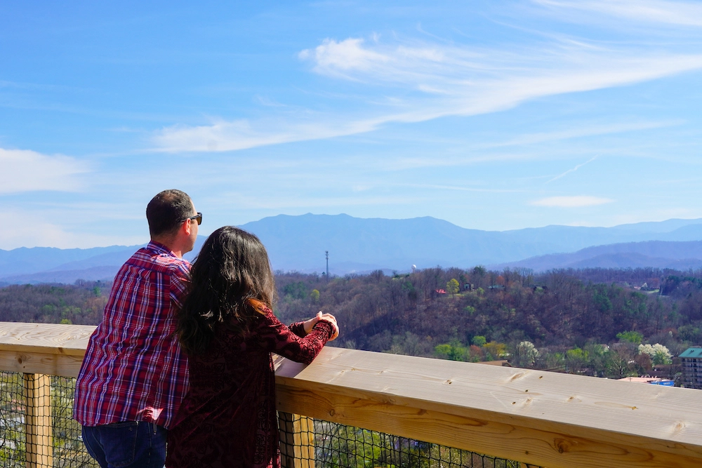 couple look out over the Smoky Mountains at Legacy Lookout