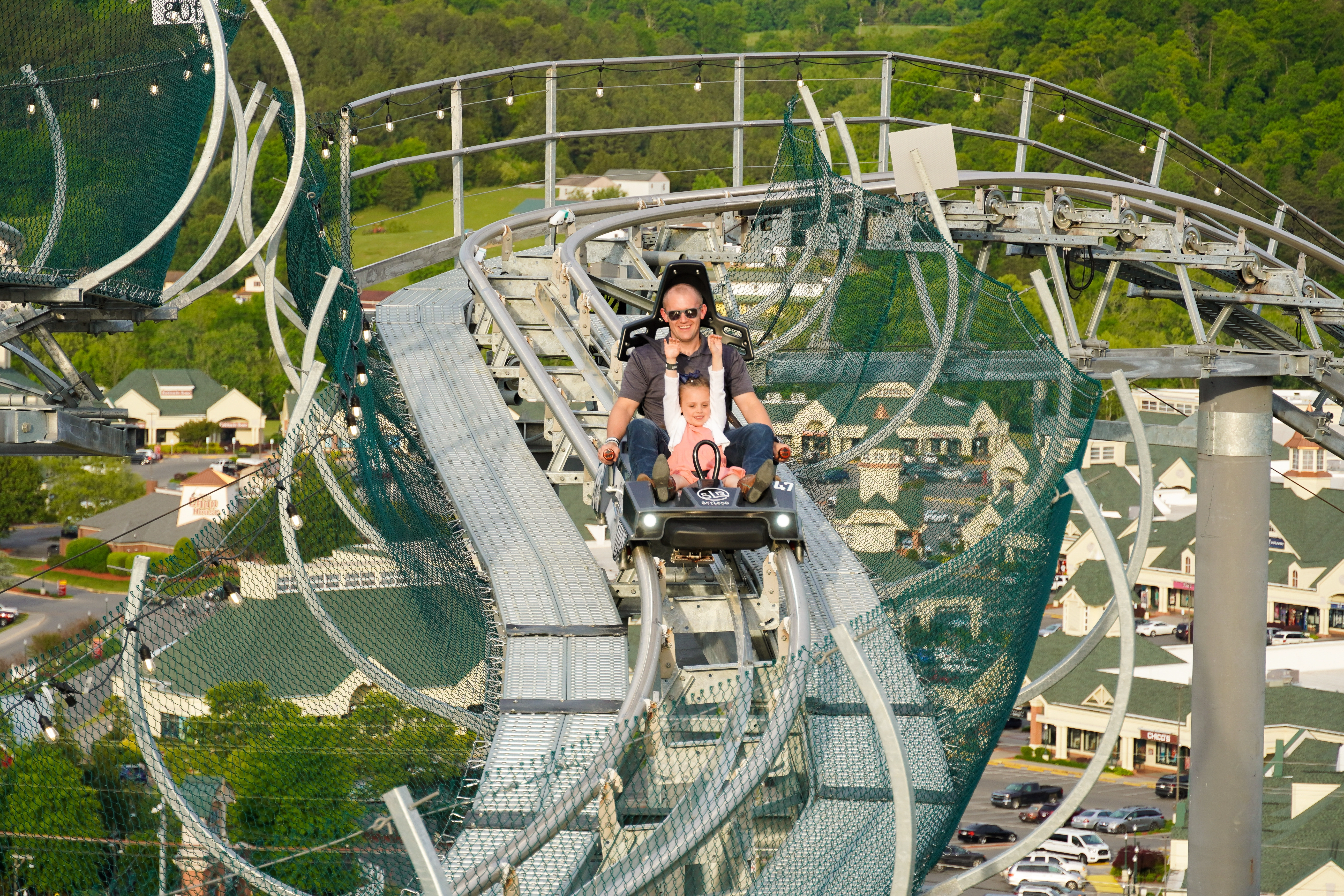 father and daughter riding the wild stallion mountain coaster