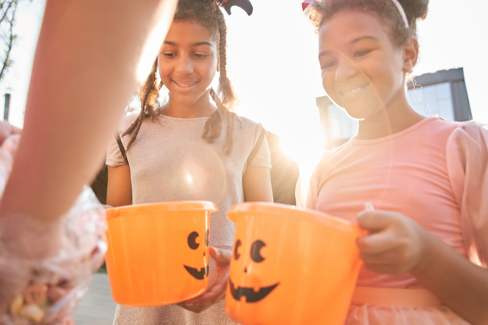 girls with Halloween buckets trick or treating